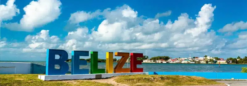 Belize Sign Overlooking Water and Houses