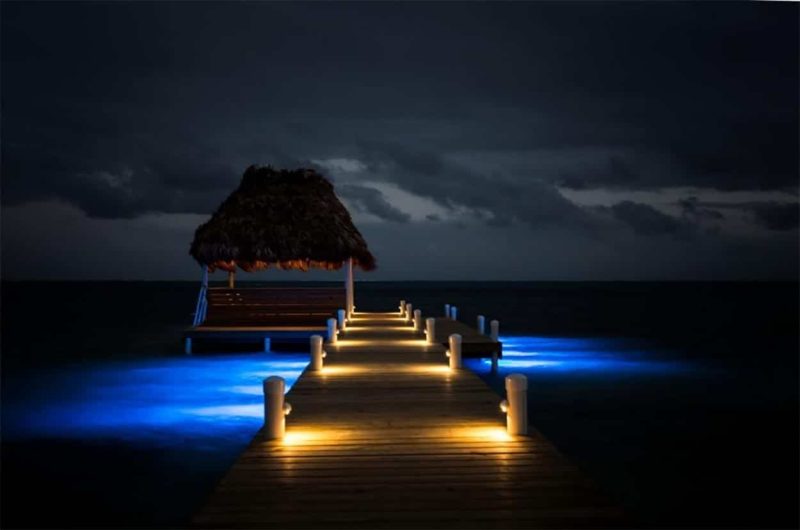 Wataview Beachfront Estate Nighttime View of Lighted Dock